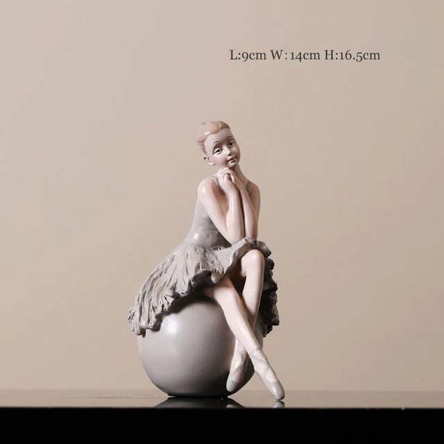 ballerina sitting on a ball