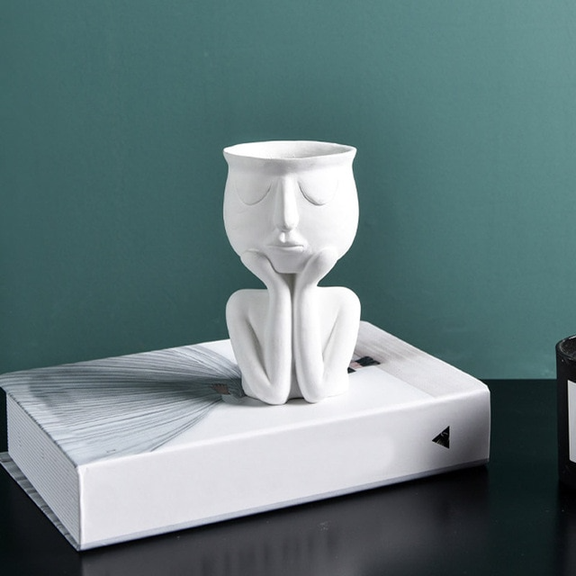 White figurine vase