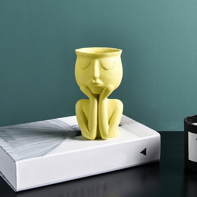 Yellow figurine vase
